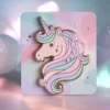 Unicorn pin displayed on a vibrant pink background, showcasing its whimsical design and colorful details.