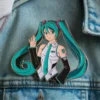 A colorful pin depicting Miku, a popular cartoon character with vibrant hair and expressive features.