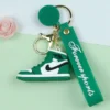 Green PVC Nike keychain featuring a shoe and a rose design, perfect for adding a stylish touch to your keys.