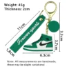 Green and white Nike shoe keychain featuring a shoe design and a measurement detail.