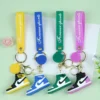 Three colorful PVC Nike keychains displaying the phrase "forever here" in bold lettering.