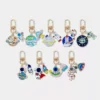 A set of six space-themed keychains, including an astronaut design, showcasing various celestial elements.