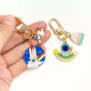 displaying a keychain with an astronaut and space theme.