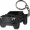 Enamel keychain shaped like a black truck, perfect for truck enthusiasts.