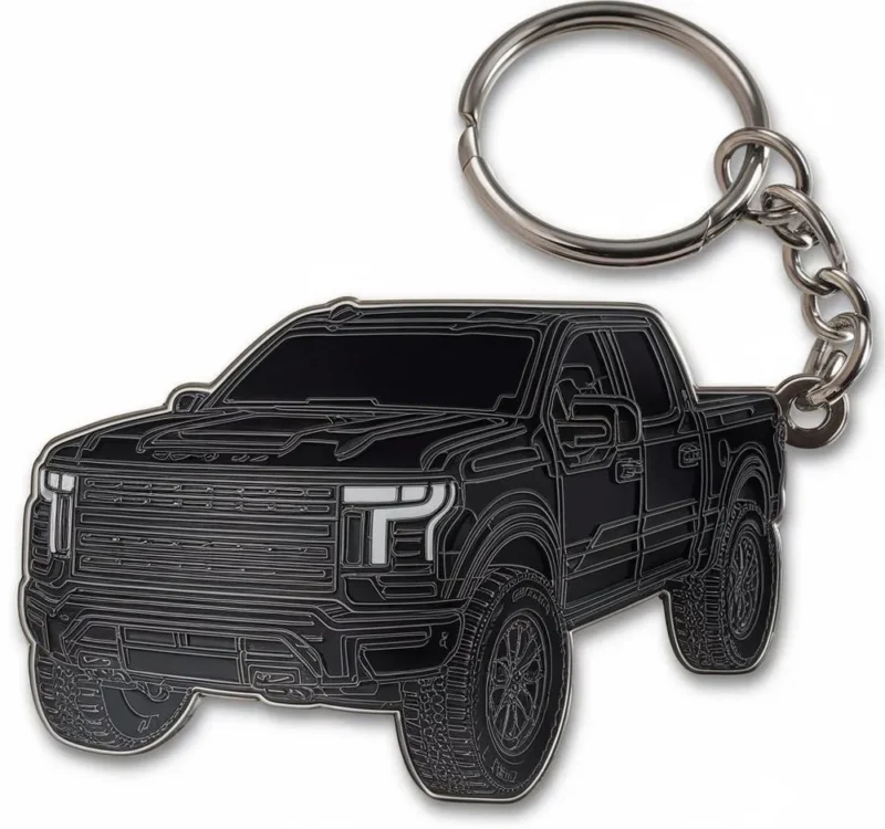 Enamel keychain shaped like a black truck, perfect for truck enthusiasts.