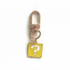 Gold Mario keychain featuring a prominent question mark design.