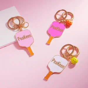 Enamel pickleball keychain featuring a playful peekaboo design, perfect for sports enthusiasts and keyring collectors.