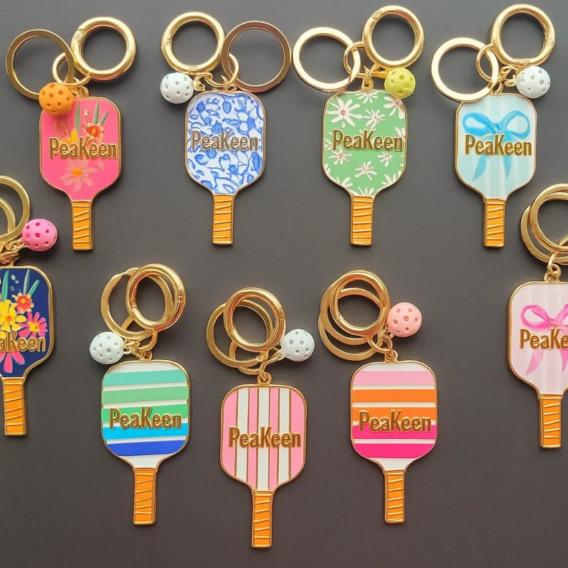 A collection of colorful enamel keychains featuring the word "Pikachu" prominently displayed on each one.