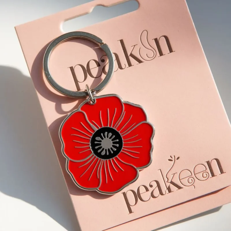 Enamel keychain featuring a vibrant red poppy flower, symbolizing remembrance and beauty.