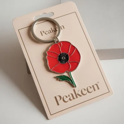 Enamel poppy keyring featuring a vibrant red poppy design, perfect for adding a touch of remembrance to your keys.