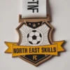 Medal featuring "North East Skills FC" text, designed for soccer achievements, with an enamel finish.