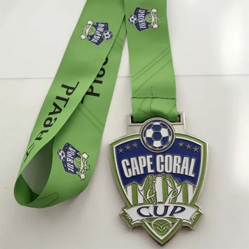 Enamel soccer medal in green, inscribed with "Cape Coral Cup" for a sports achievement recognition.