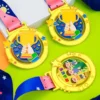 Three colorful kid medals with ribbons and stars, symbolizing achievement and participation in activities.