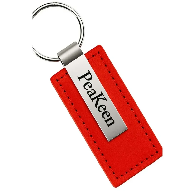 Red embossed leather keychain featuring the name "Peakeen" prominently displayed.