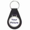 Black leather keychain featuring a white circle in the center, designed with an embossed texture for added style.