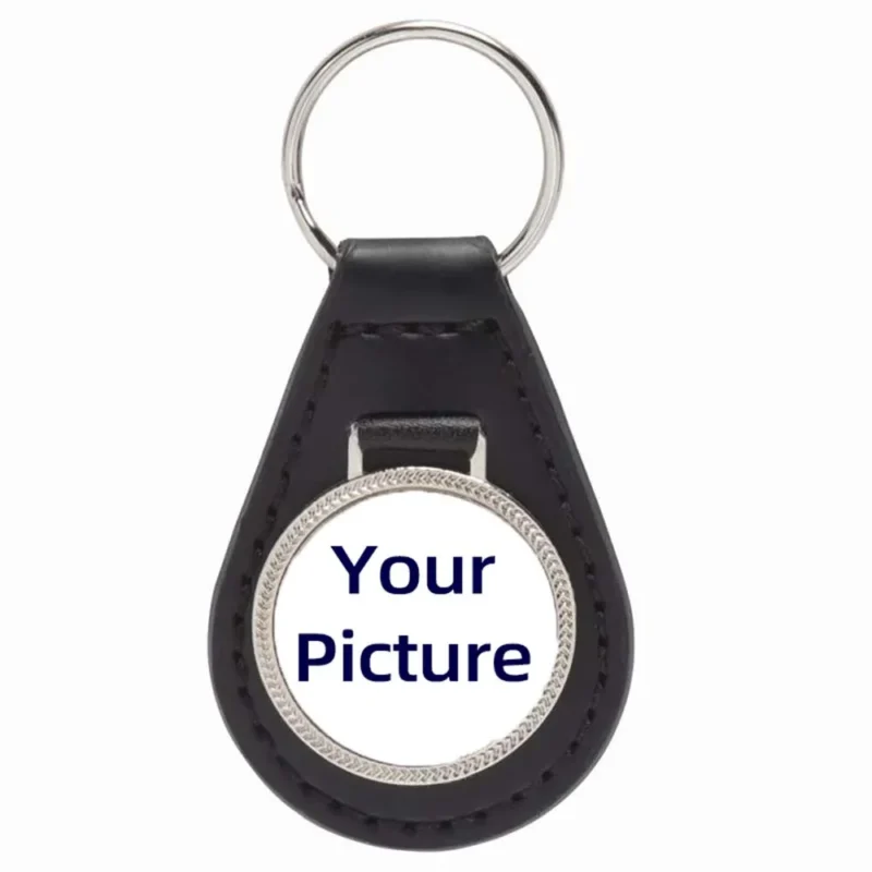 Black leather keychain featuring a white circle in the center, designed with an embossed texture for added style.