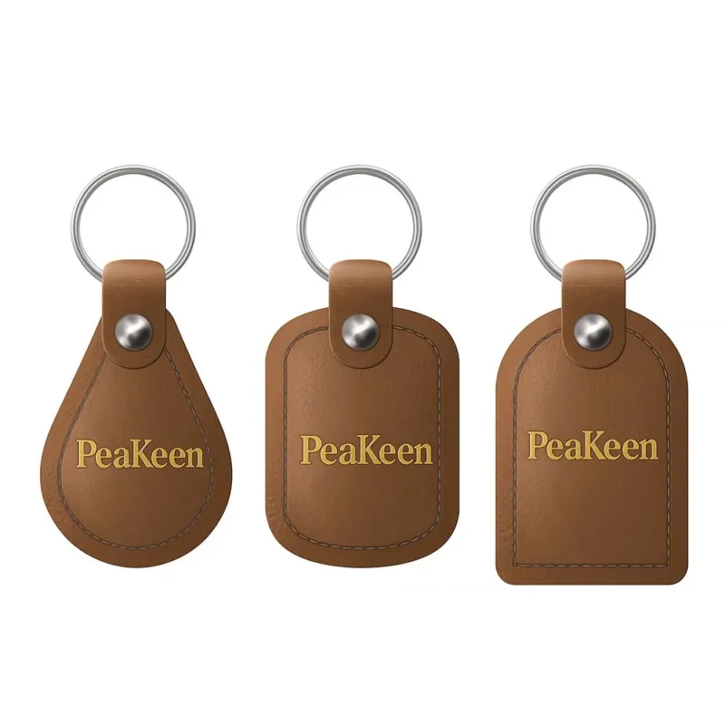 Three embossed leather keychains featuring the word "peakeen" on each tag.