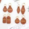 Several embossed leather keychains, each embossed with the word "peakeen," arranged together.
