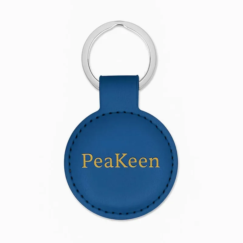Round keychain in blue, crafted from embossed leather, offering a personalized touch and elegant appearance.