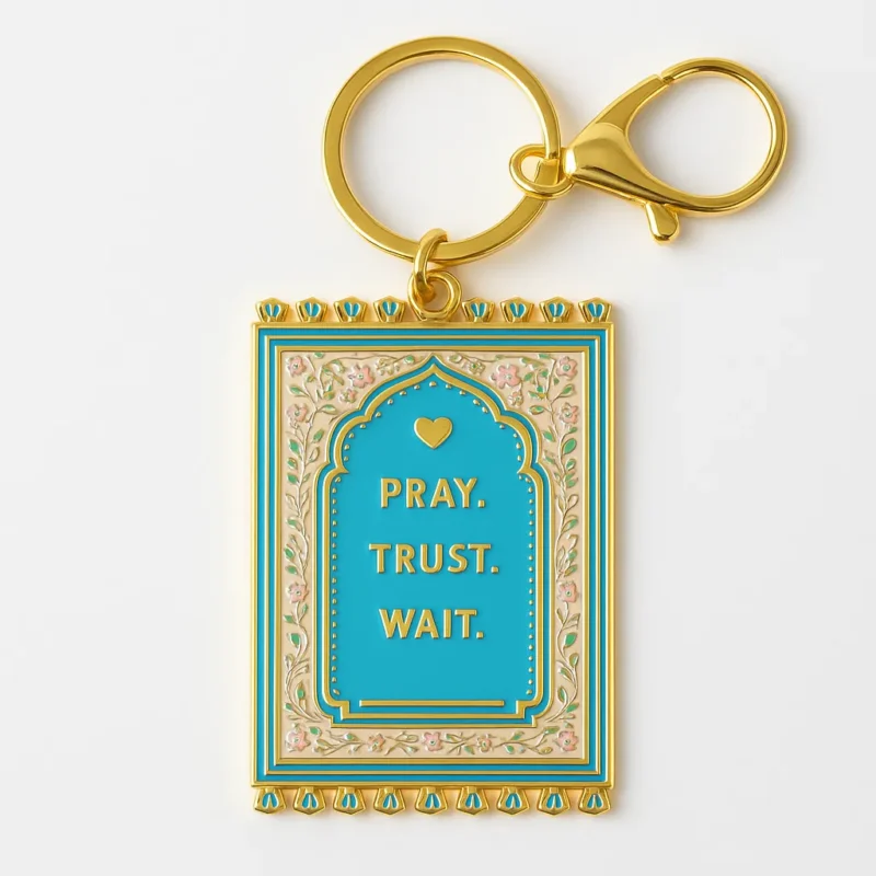 Keychain featuring the words "pray, trust, wait" alongside a small prayer mat design.