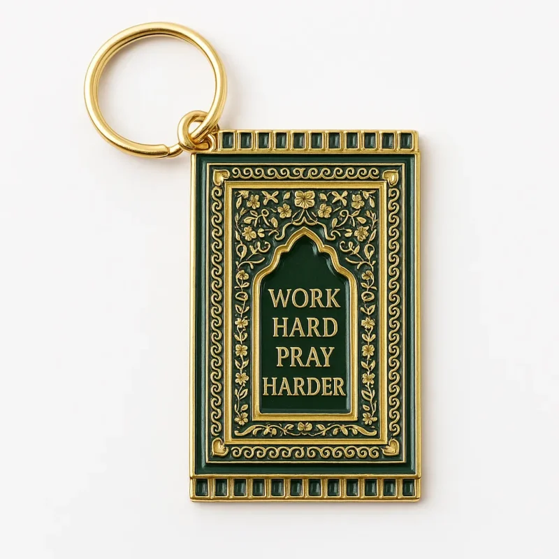 Keychain featuring the phrase "Work Hard Pray Harder" alongside a small prayer mat design.