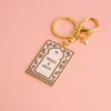 Gold keychain featuring a peace message in Islam, designed as a prayer mat keychain.