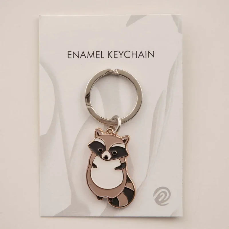 A keychain featuring a cute raccoon design, perfect for animal lovers and adding charm to your keys.