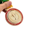 A person proudly holds a gold medal with a ribbon, showcasing their achievement in spinning medals.