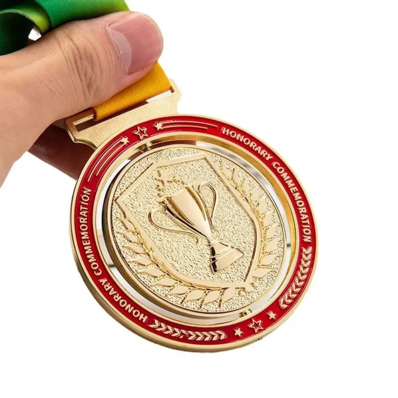 A person proudly holds a gold medal with a ribbon, showcasing their achievement in spinning medals.