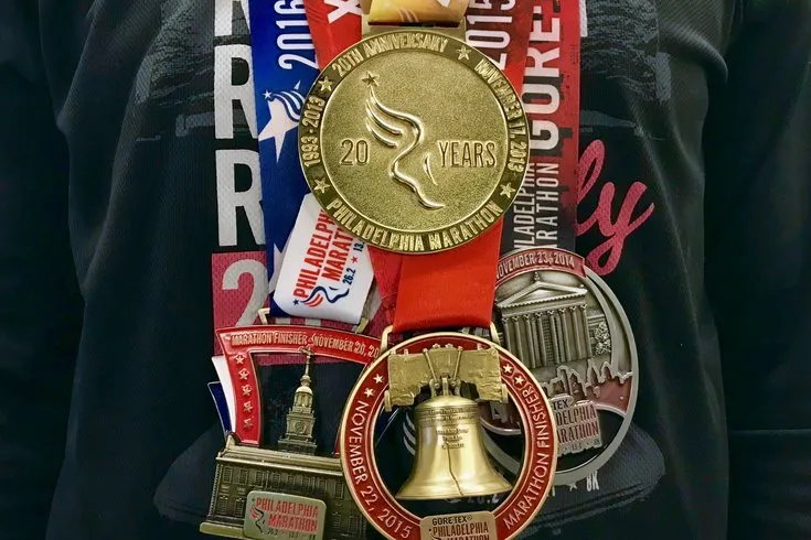 A display of Philadelphia Marathon finisher medals from 2013 through 2016