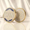 Two gold and white challenge coins displaying the words "win" and "lose," symbolizing a flipping challenge.