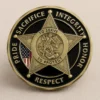Badge featuring the words "sacrifice, integrity, honor, respect" representing Sheriff Department Challenge Coins.
