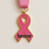 Pink ribbon with the word "Survivor," symbolizing triumph over breast cancer, often used in medals.