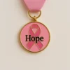 A pink ribbon featuring the word "hope," symbolizing support for breast cancer awareness and medals.