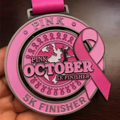 Pink October 5K finisher medal, symbolizing support for breast cancer awareness and survivors.
