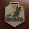 3D printed handball medal featuring a detailed design, showcasing the sport's emblem and winner's ribbon.