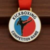 A kickboxing medal featuring the name of the competition engraved on its surface.