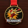 Kickboxing medal hanging from a red ribbon, set on a black backdrop.