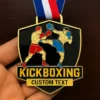 A kickboxing medal featuring a prominent kickboxing logo, symbolizing achievement in the sport.