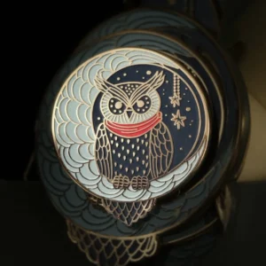 Owl enamel pin featuring a detailed, colorful owl design on a round background.