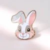 White and pink bunny enamel pin featuring a cute rabbit design, perfect for accessorizing bags or jackets.