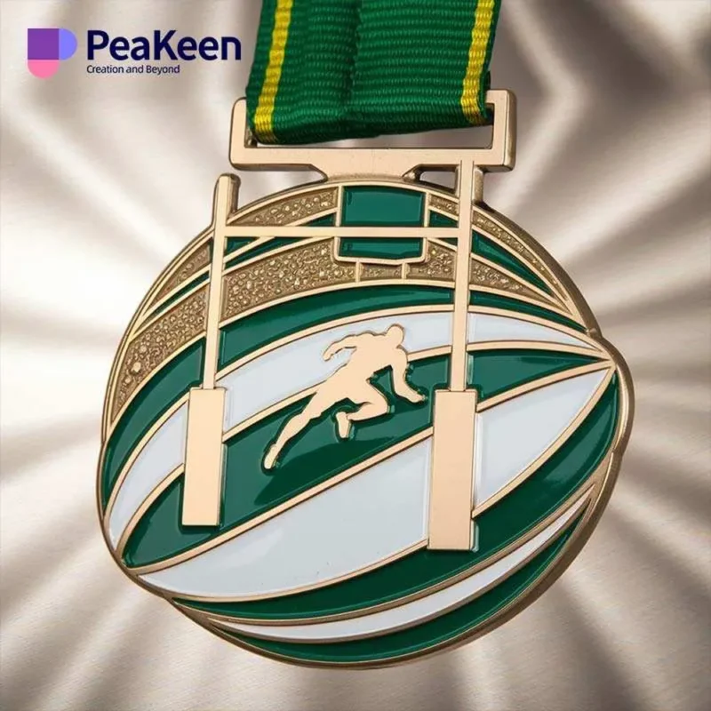 Gold medal with a green ribbon featuring a rugby ball design, representing rugby achievements.