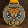 A medal featuring the word "tiger" prominently displayed on its surface.