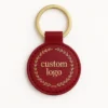 Genuine leather keychain featuring a gold logo on a stylish red leather design.