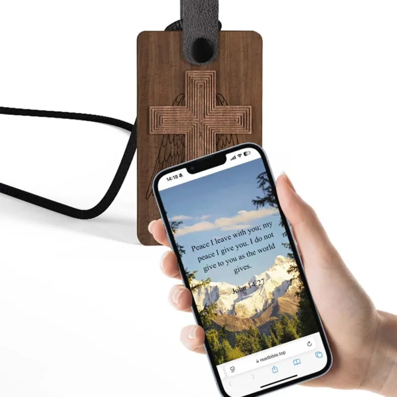 Wooden cross luggage tag attached to an NFC Bible necklace, combining travel and faith in a unique accessory.