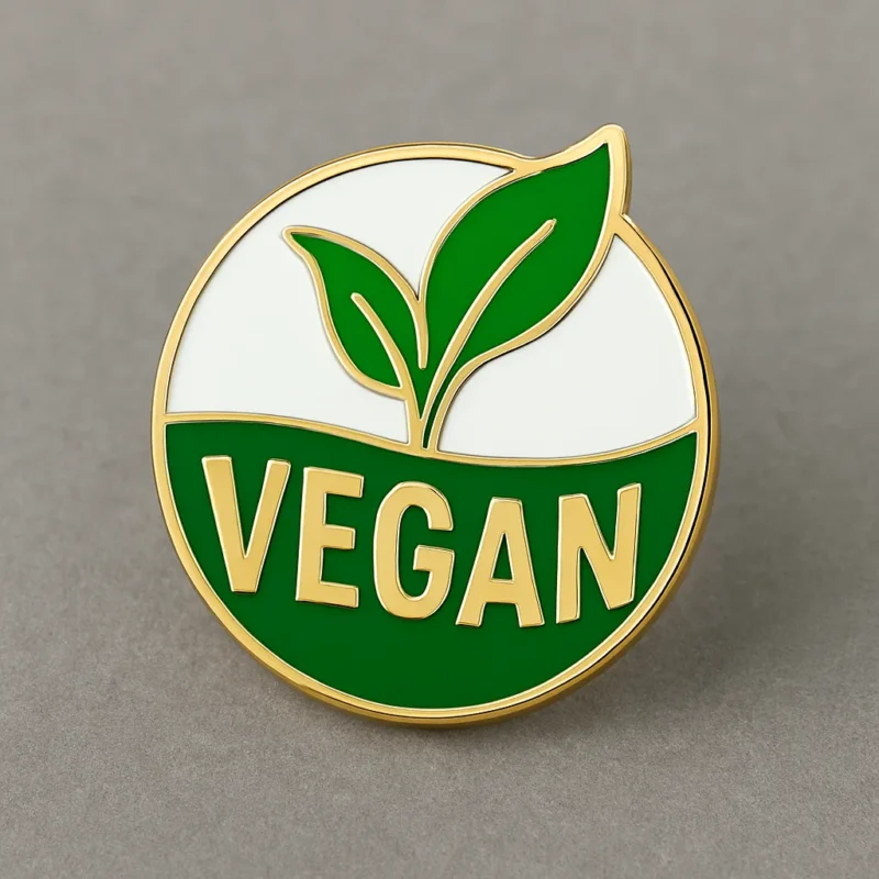 Green leaf icon with the word "vegan" on a circular badge design.