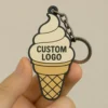 A hand holding a colorful ice cream cone keychain, showcasing a fun and playful accessory.