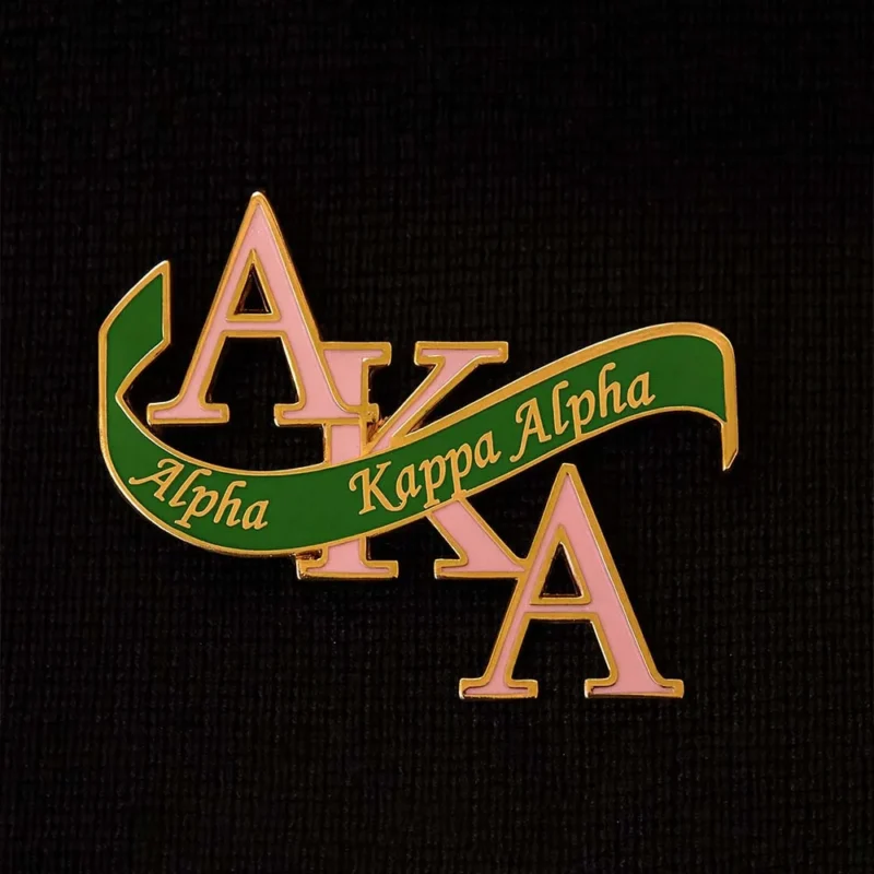 Alpha Kappa Alpha sorority pin featuring the organization's signature colors and emblematic design.
