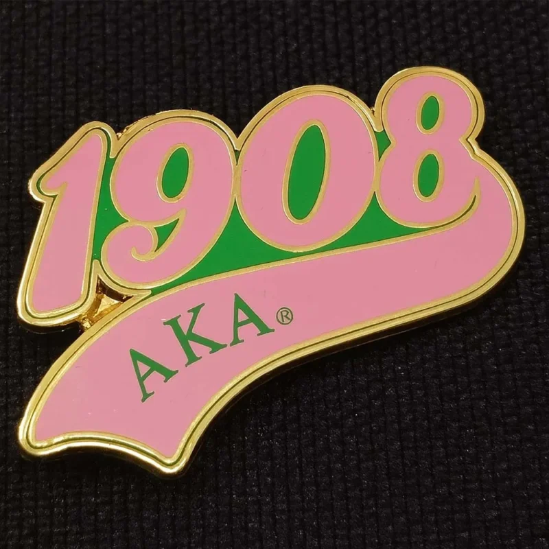 A pink and green pin featuring the year "1908" prominently displayed.