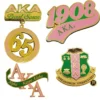 Alpha Kappa Phi pin set featuring intricate designs, representing membership and unity within the organization.